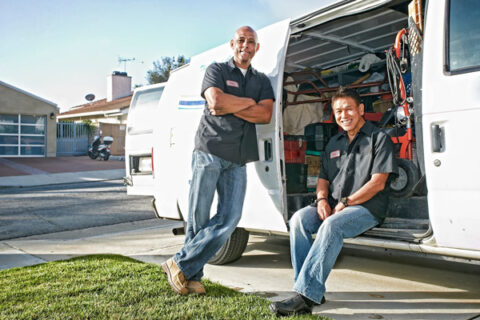 Owner of company standing near van.